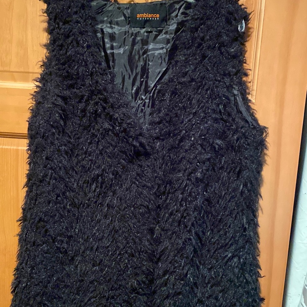 Women’s black fur vest. Hook and eye closure, size L.